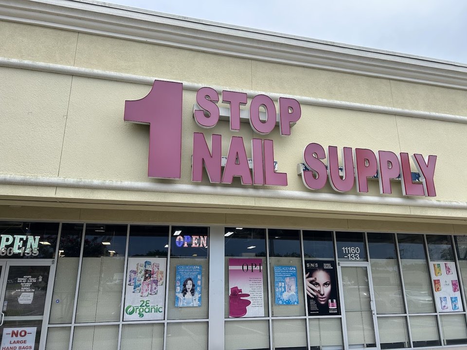 Shelves of nail supplies and polish inside a beauty store.