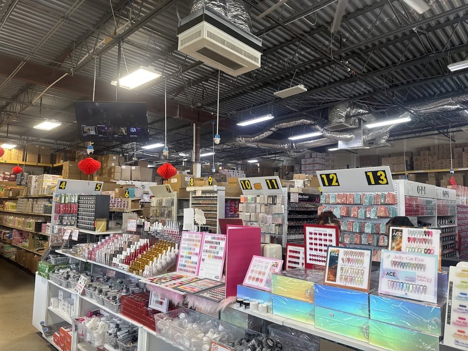 A bright aisle lined with nail products and tools.