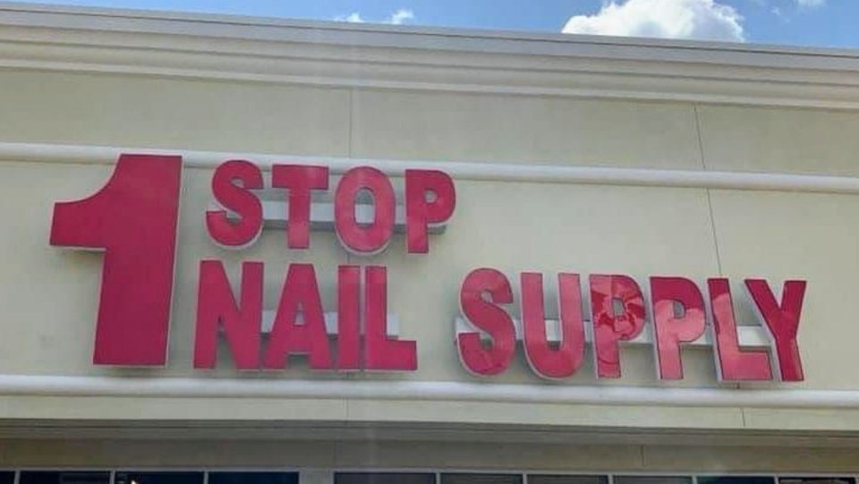 A bright aisle lined with nail products and tools.